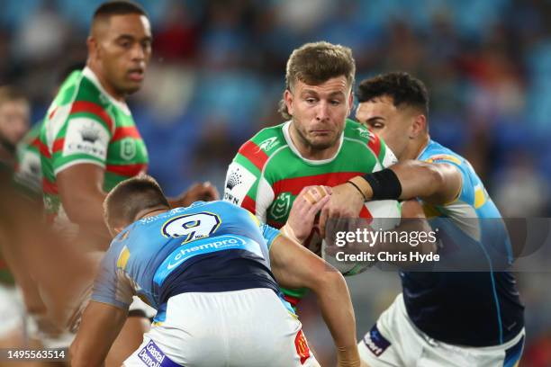 Jai Arrow of the Rabbitohs is tackled during the round 14 NRL match between Gold Coast Titans and South Sydney Rabbitohs at Cbus Super Stadium on...