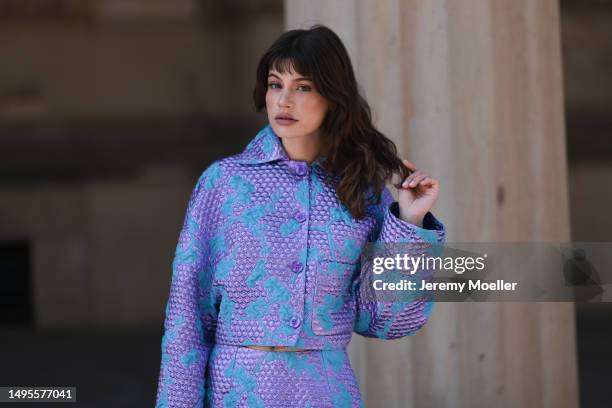 Lea Naumann wearing aesther ekme black leather bucket bag, Baum & Pferdgarten metallic shiny matching cropped blue and lilac jacket and midi skirt...