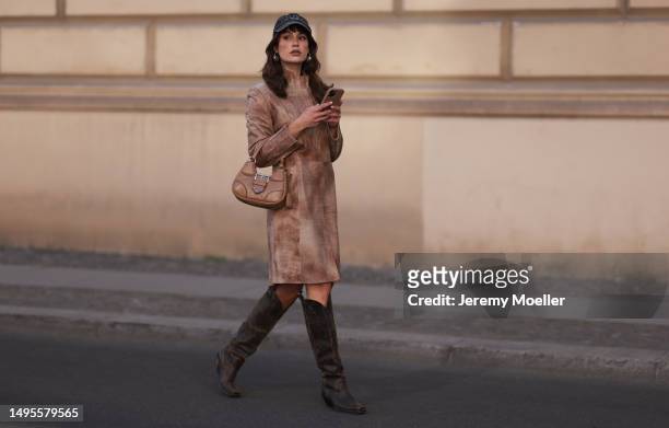 Lea Naumann wearing Vintage beige leather shoulder pads coat, Diesel brown leather boots, Prada beige leather Moon bag and New York grey capon June...