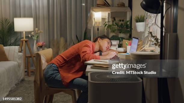 young asian woman wear casual sit front of desk with computer laptop feeling unhappy stressed about debt problem on work idea in living room at house at night. work from home. - job search stress stock pictures, royalty-free photos & images