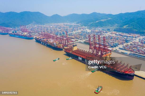 Aerial view of tugboats pushing "MSC Michel Cappellini" container ship at Ningbo Zhoushan Port on June 2, 2023 in Ningbo, Zhejiang Province of China....