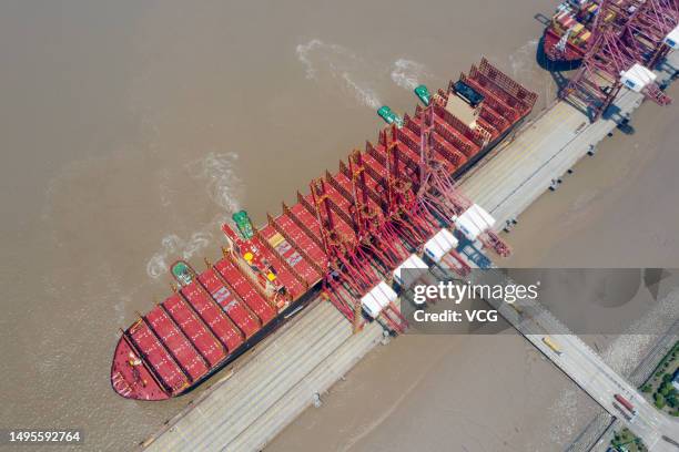 Aerial view of tugboats pushing "MSC Michel Cappellini" container ship at Ningbo Zhoushan Port on June 2, 2023 in Ningbo, Zhejiang Province of China....