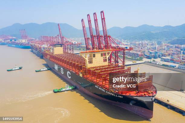 Aerial view of tugboats pushing "MSC Michel Cappellini" container ship at Ningbo Zhoushan Port on June 2, 2023 in Ningbo, Zhejiang Province of China....