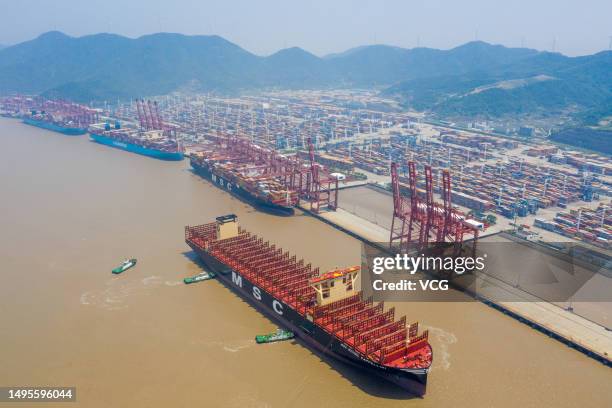 Aerial view of tugboats pushing "MSC Michel Cappellini" container ship at Ningbo Zhoushan Port on June 2, 2023 in Ningbo, Zhejiang Province of China....