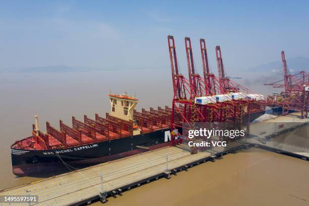 Aerial view of tugboats pushing "MSC Michel Cappellini" container ship at Ningbo Zhoushan Port on June 2, 2023 in Ningbo, Zhejiang Province of China....