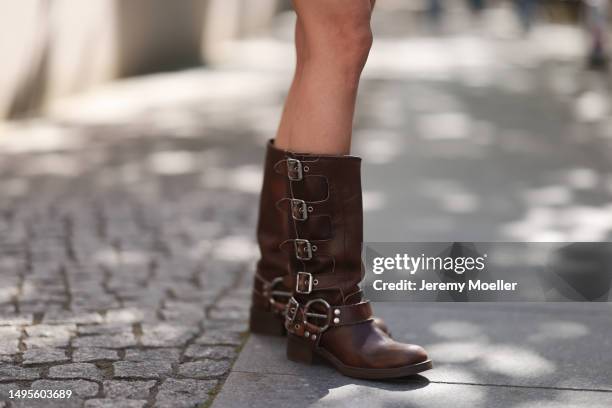 Lea Naumann wearing Miu Miu brown leather Metall boots, Prada beige leather Moon bag, Nisse mini dress with crystal and Pearl details, Acne Studios...