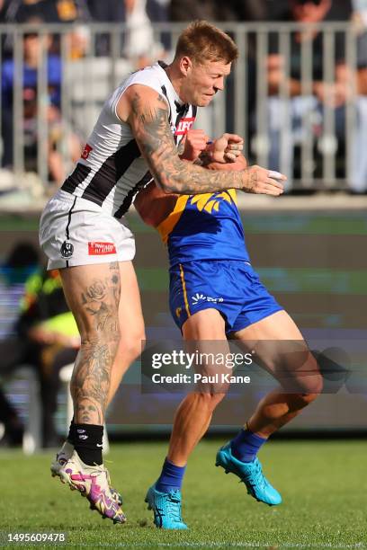 Jordan De Goey of the Magpies bumps Elijah Hewett of the Eagles during the round 12 AFL match between West Coast Eagles and Collingwood Magpies at...