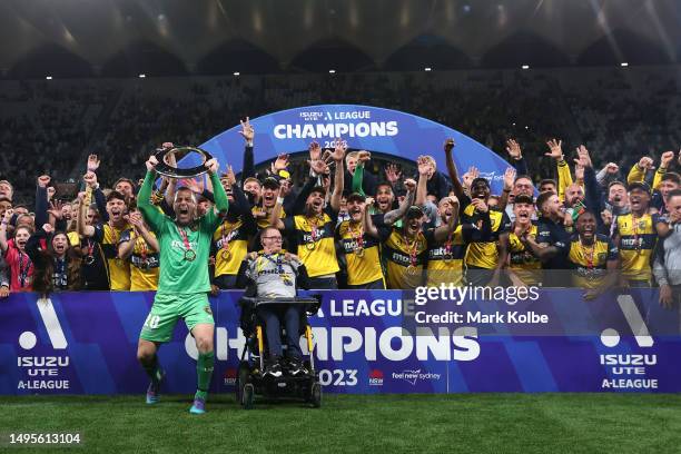 Daniel Vukovic of the Mariners holds aloft the A-League Trophy after winning the 2023 A-League Men's Grand Final match between Melbourne City and...