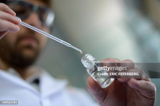 By SANDRA LACUT - FILES - Picture taken on July 4, 2012 shows a student testing a fragrance melt in a aboratory at the Givaudan Perfumery School in...