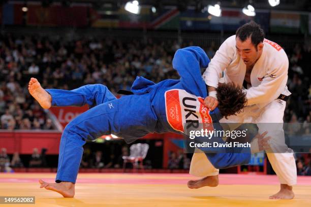Eventual Bronze A medallist Nyam-Ochir Sainjargal of Mongolia scores with a foot sweep against Volodymyr Soroka of Ukraine during the -73 kg Judo on...