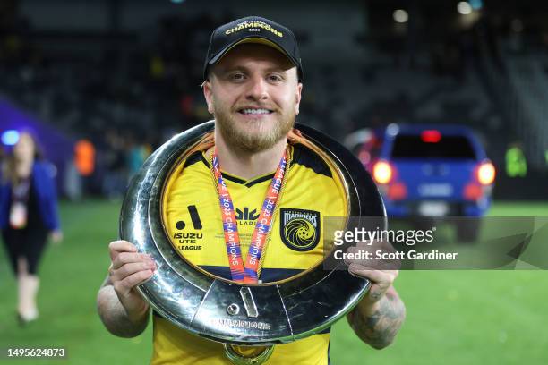 Jason Cummings of the Mariners post game with the A-League trophy during the 2023 A-League Men's Grand Final match between Melbourne City and Central...