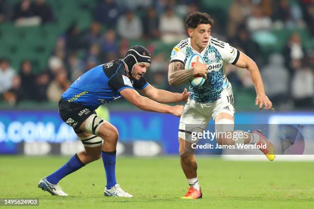 Rivez Reihana of the Chiefs attempts to break away from the tacklers during the round 15 Super Rugby Pacific match between Western Force and Chiefs...