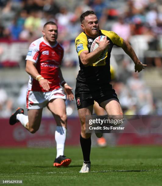 Joe Burgess of Salford breaks to score their first try during the Betfred Super League Magic Weekend match between Salford Red Devils and Hull KR at...