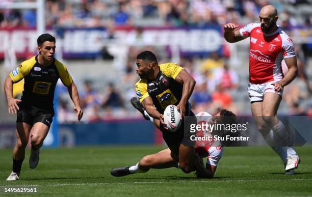Salford player Kallum Watkins breaks a tackle during the Betfred Super League Magic Weekend match between Salford Red Devils and Hull KR at St James'...
