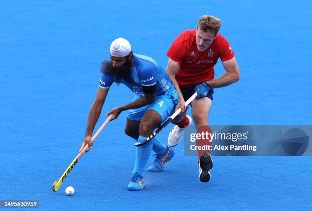 Singh Jarmanpreet of India is tackled by James Oates of Great Britain during the FIH Hockey Pro League Men's match between Great Britain and India at...