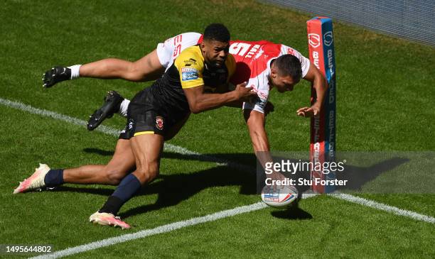 Hull KR player Ryan Hall scores a try despite the efforts of Salford player Kallum Watkins during the Betfred Super League Magic Weekend match...