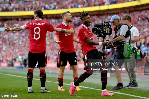 Fred of Manchester United celebrates alongside teammate Bruno Fernandes who scored the team's first goal from the penalty spot during the Emirates FA...