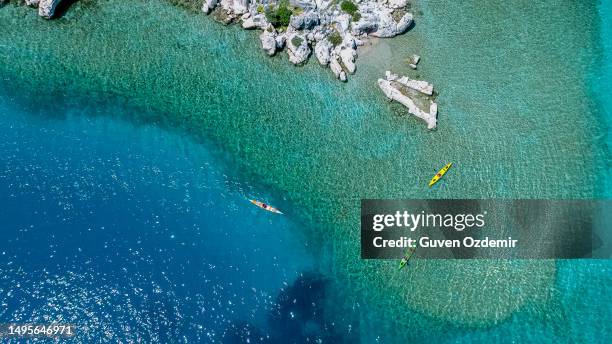 aerial view of people canoeing on the mediterranean coast, person canoeing in antalya-kaleköy, enjoying the beautiful view, weekend activity, activities to do alone, friend activity, water sports - mugla province stock pictures, royalty-free photos & images