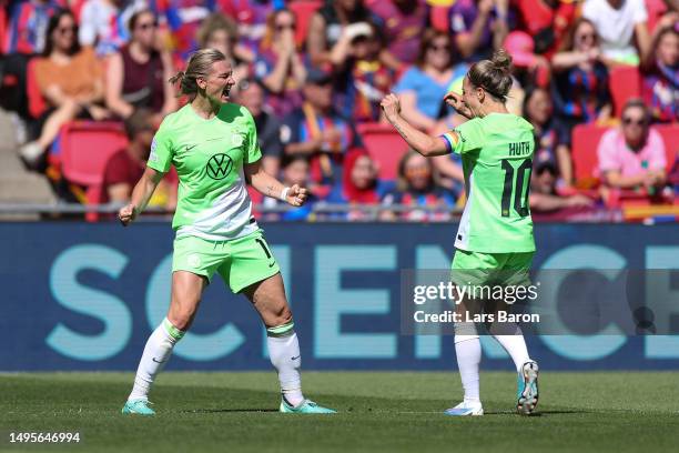 Alexandra Popp of VfL Wolfsburg celebrates with teammate Svenja Huth after scoring the team's second goal during the UEFA Women's Champions League...