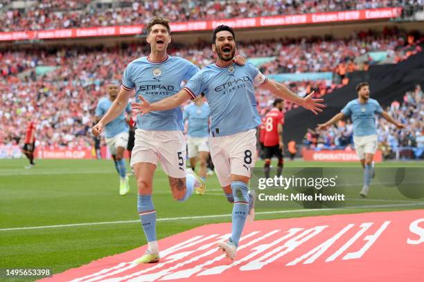 Ilkay Guendogan of Manchester City celebrates with teammate John Stones after scoring the team's second goal during the Emirates FA Cup Final between...