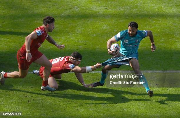 Wigan player Bevan French has his shorts pulled in the tackle by Catalan player Ben Garcia during the Betfred Super League Magic Weekend match...