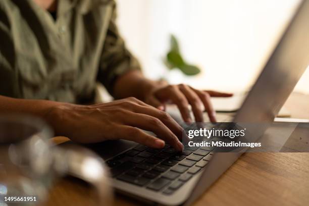 close up on woman hand typing on keyboard - extreme close up stock pictures, royalty-free photos & images
