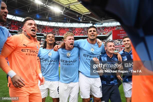 Ederson, Nathan Ake, Kevin De Bruyne and Rodri of Manchester City celebrate following the team's victory in the Emirates FA Cup Final between...