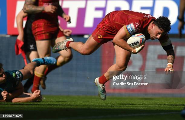 Catalans player Arthur Romano dives over to score a try during the Betfred Super League Magic Weekend match between Wigan Warriors and Catalans...