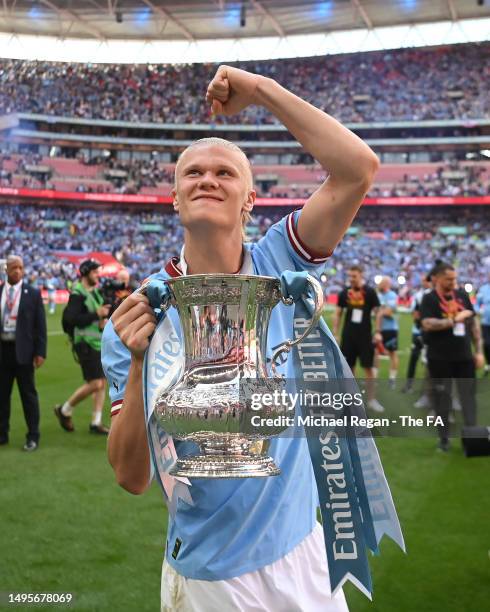 Erling Haaland of Manchester City celebrates with the FA Cup trophy, after their side's victory during the Emirates FA Cup Final between Manchester...