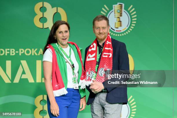 Prime minister of Saxony Michael Kretschmer and his wife Annett Hofmann pose for a picture at the VIP entrance prior to the DFB Cup final match...