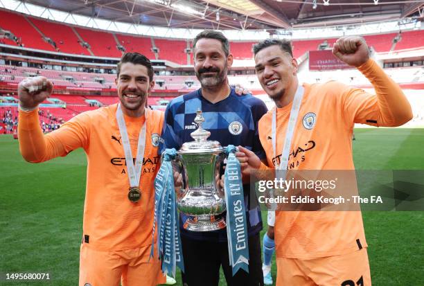 Stefan Ortega poses for a photograph with Scott Carson and Ederson of Manchester City with the FA Cup Trophy after the Emirates FA Cup Final between...