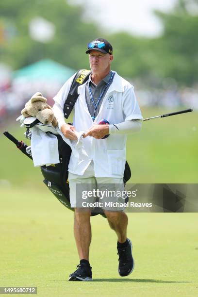 Caddie Joe LaCava walks the first fairway during the third round of the Memorial Tournament presented by Workday at Muirfield Village Golf Club on...