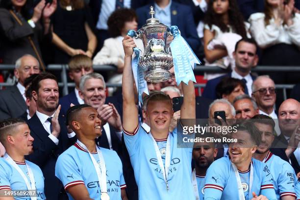 Erling Haaland of Manchester City lifts the FA Cup Trophy after the team's victory in the Emirates FA Cup Final between Manchester City and...