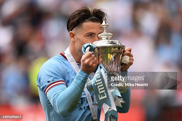 Jack Grealish of Manchester City kisses the FA Cup Trophy after the team's victory in front of their fans after the Emirates FA Cup Final between...