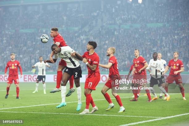 Willi Orban of RB Leipzig jumps for the ball with Evan Ndicka of Eintracht Frankfurt during the DFB Cup final match between RB Leipzig and Eintracht...