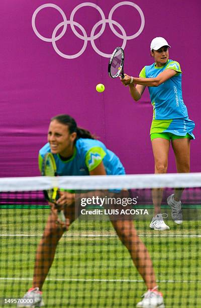 Slovenia's Katarina Srebotnik and Andreja Klepac serve to Italy's Sara Errani and Roberta Vinci during their London 2012 Olympic Games women's...