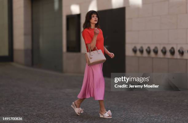 Lea Naumann wearing Acne Studios satin beige rose flower heels, Samsoe Samsoe pink satin midi skirt, Gestuz orange red tshirt and Prada Galleria...