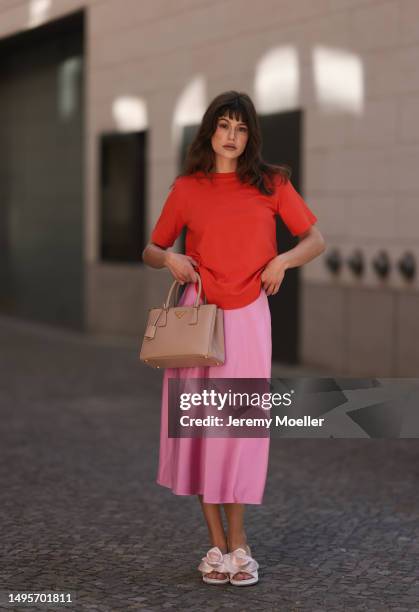 Lea Naumann wearing Acne Studios satin beige rose flower heels, Samsoe Samsoe pink satin midi skirt, Gestuz orange red tshirt and Prada Galleria...