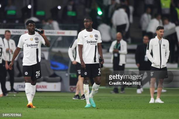 Evan Ndicka and Junior Dina Ebimbe of Eintracht Frankfurt look dejected after the team's defeat during the DFB Cup final match between RB Leipzig and...