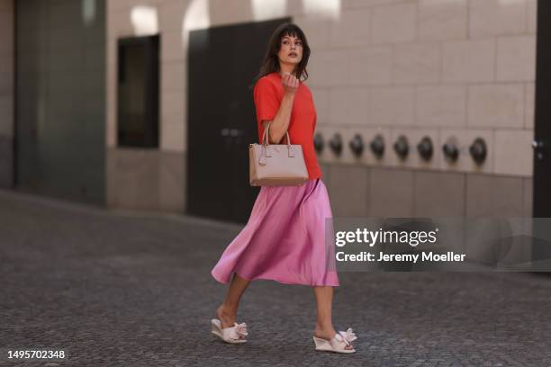 Lea Naumann wearing Acne Studios satin beige rose flower heels, Samsoe Samsoe pink satin midi skirt, Gestuz orange red tshirt and Prada Galleria...