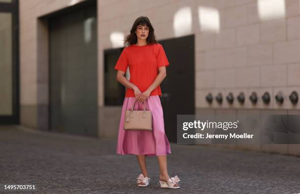 Lea Naumann wearing Acne Studios satin beige rose flower heels, Samsoe Samsoe pink satin midi skirt, Gestuz orange red tshirt and Prada Galleria...