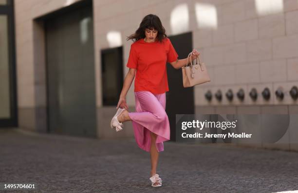 Lea Naumann wearing Acne Studios satin beige rose flower heels, Samsoe Samsoe pink satin midi skirt, Gestuz orange red tshirt and Prada Galleria...