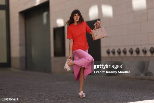 Lea Naumann wearing Acne Studios satin beige rose flower heels, Samsoe Samsoe pink satin midi skirt, Gestuz orange red tshirt and Prada Galleria...