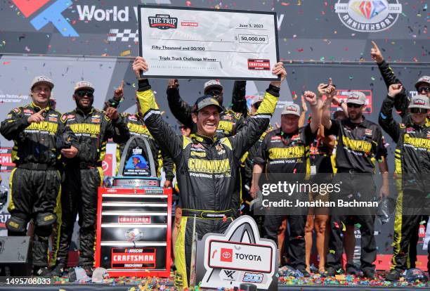 Grant Enfinger, driver of the Champion Power Equipment Chevrolet, celebrates with the Triple Truck Challenge $50,000.00 check, in victory lane after...