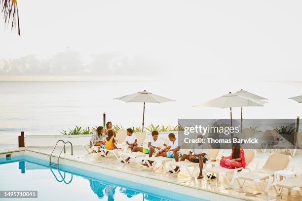 wide shot family having breakfast by pool at all inclusive resort - all inclusive holiday stock pictures, royalty-free photos & images
