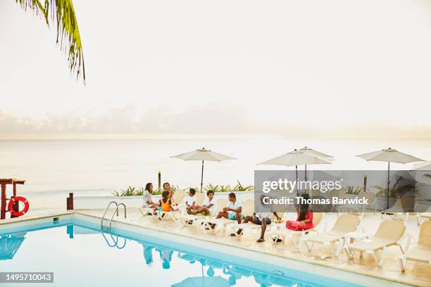 wide shot family having breakfast by pool at all inclusive resort - all inclusive holiday stock pictures, royalty-free photos & images