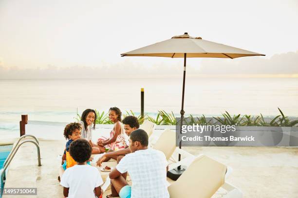 wide shot siblings having breakfast by pool at all inclusive resort - all inclusive holiday stock pictures, royalty-free photos & images