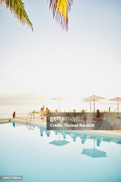 wide shot family having breakfast by pool at all inclusive resort - all inclusive holiday stock pictures, royalty-free photos & images