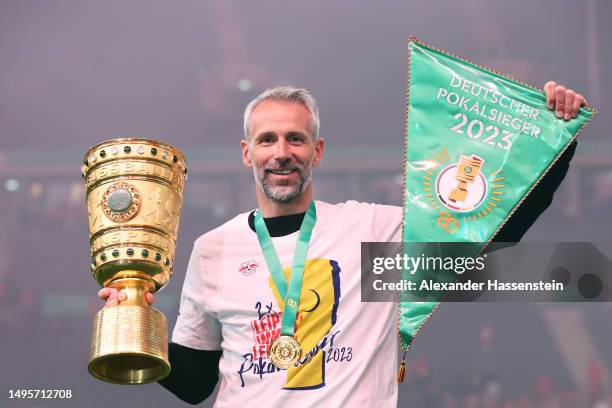 Marco Rose, Head Coach of RB Leipzig, celebrates with the DFB Cup trophy and a match pennant after the DFB Cup final match between RB Leipzig and...