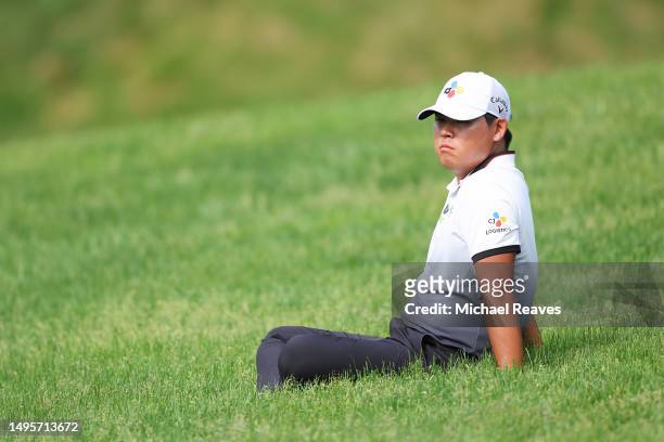 Si Woo Kim of South Korea watches Mark Hubbard of the United States play on the 17th fairway during the third round of the Memorial Tournament...